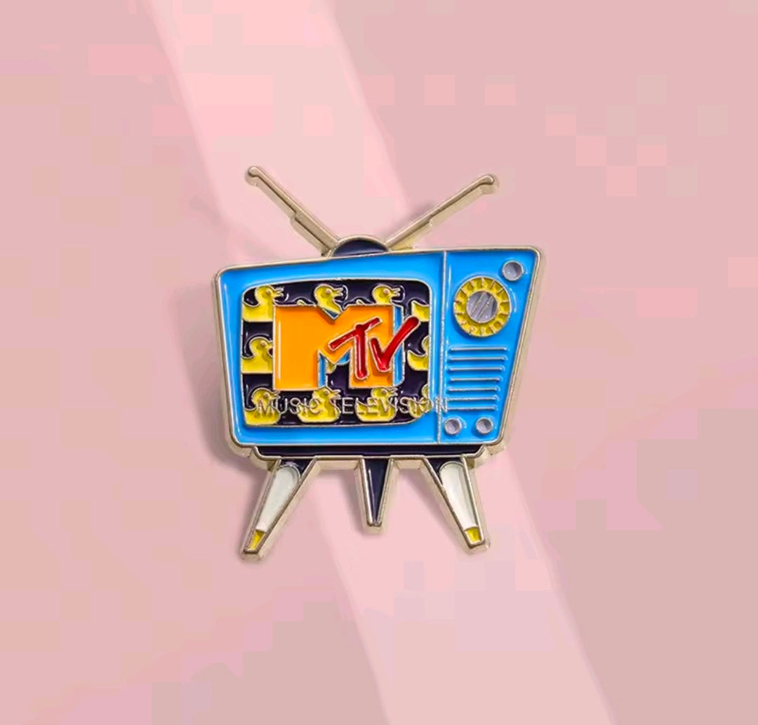 Retro TV enamel pin featuring the MTV logo inside a blue screen with gold antenna posts