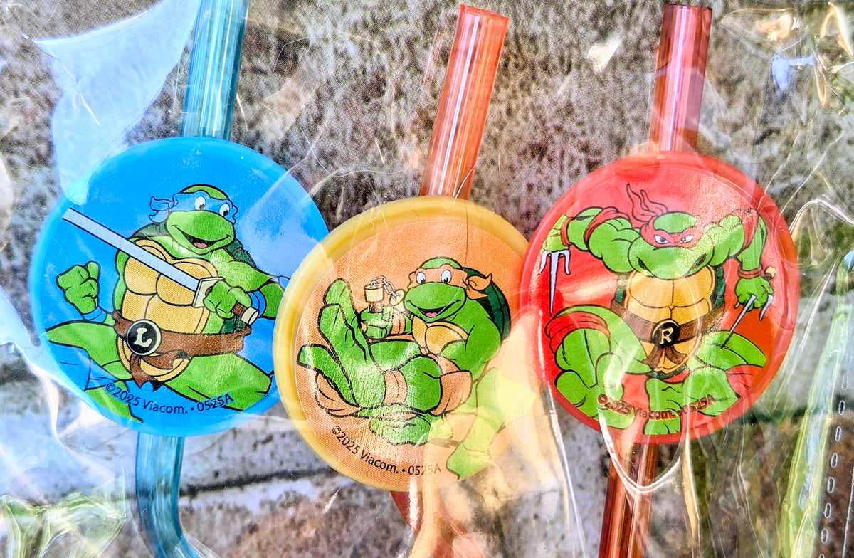 Three Turtle-themed silly straw tops in blue, orange, and red character circles