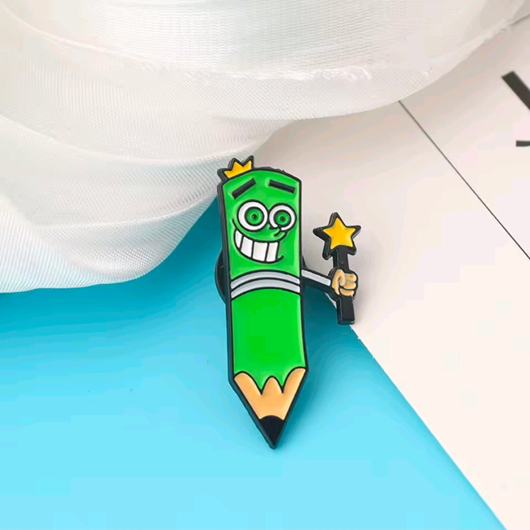 Close-up of a green enamel character pin holding a star-shaped wand
