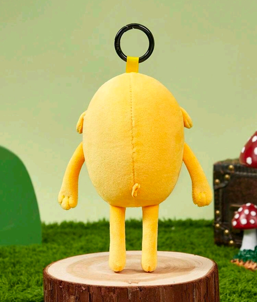 Yellow Jake the Dog plush bag charm keychain with black keyring loop and round body.