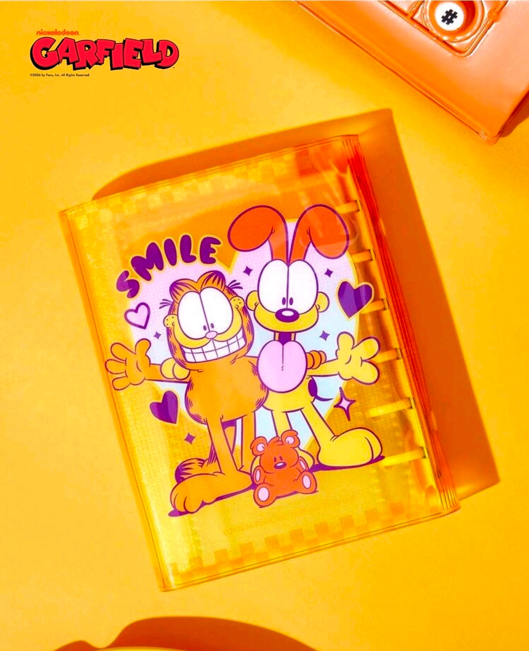 A7 sticker photo album planner with clear orange cover showing cartoon characters inside