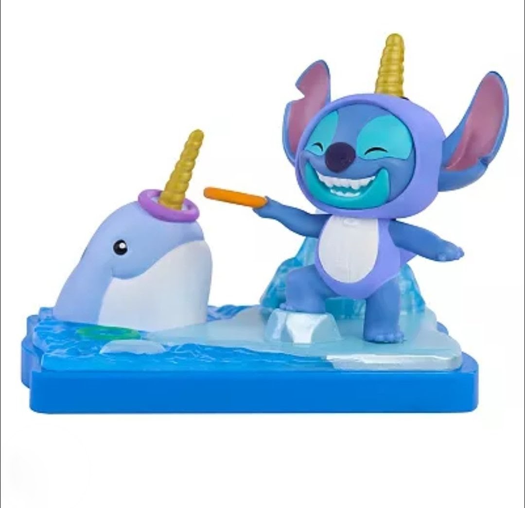 Stitch blind box figure on blue base with unicorn beside him and orange horn accessory