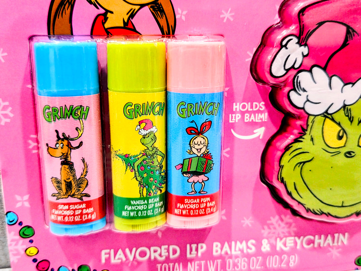 Three flavored lip balm tubes (blue, green, pink) with Grinch keychain holder