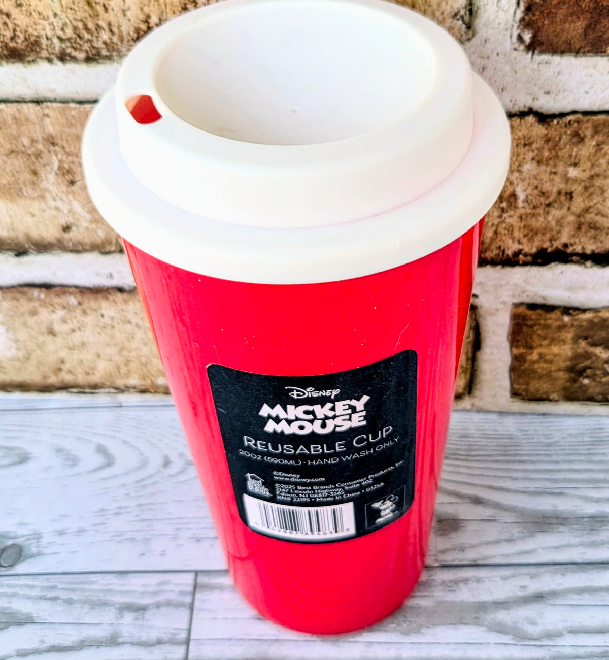 Red reusable cup with white lid, front label reading Reusable Cup