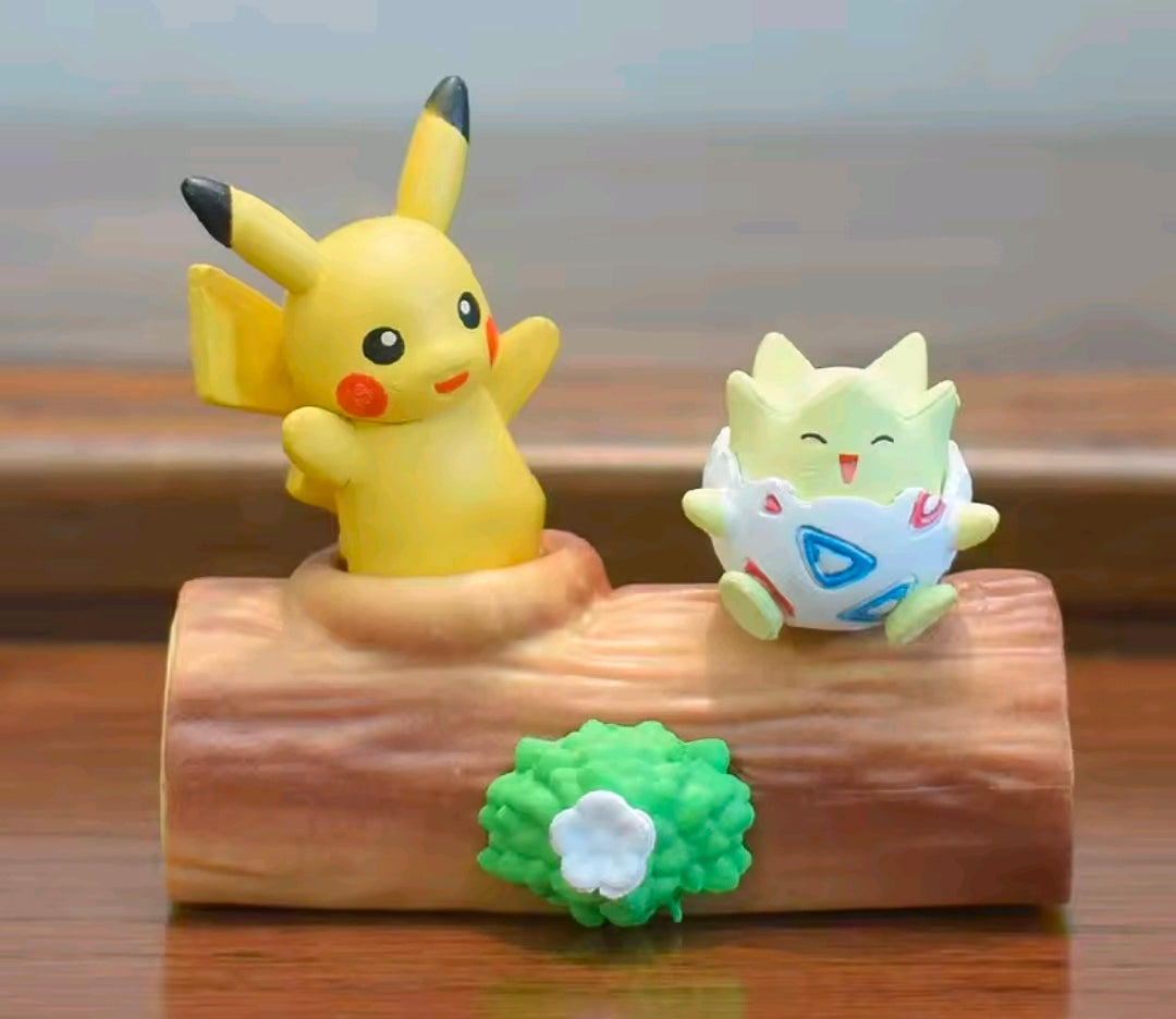 Pikachu and Togepi mini blind box figures on a brown log base