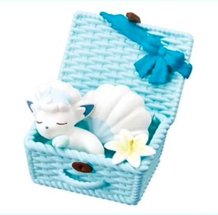 Alolan Vulpix nap basket figure with blue bow and white sleeping character.