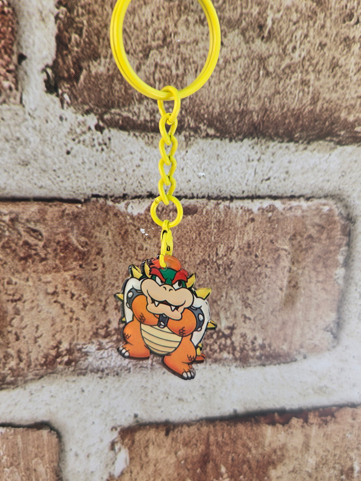 Bowser acrylic keychain with yellow ring and chain, facing forward character