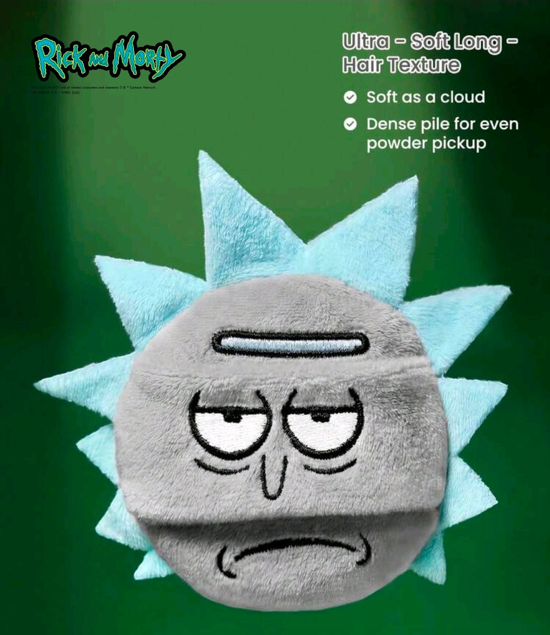 Round plush gray character powder puff with stitched tired eyes and frown, spiky light-blue backing.