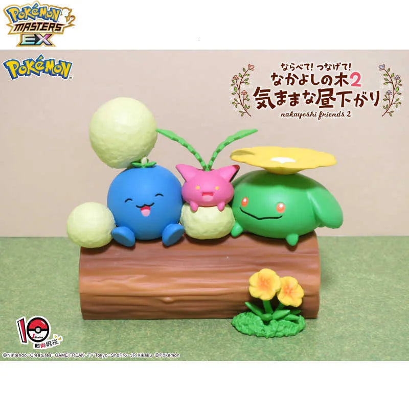 Flower-themed toy figures on a brown log with yellow flower and green vine accents.
