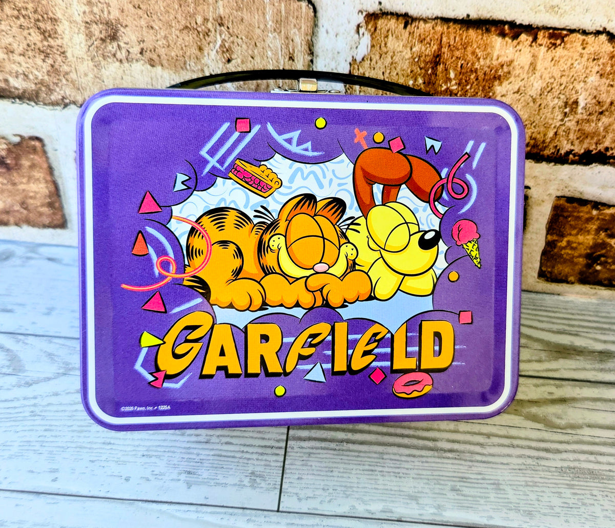 Purple Garfield pet tin lid with Garfield lettering and colorful confetti shapes.