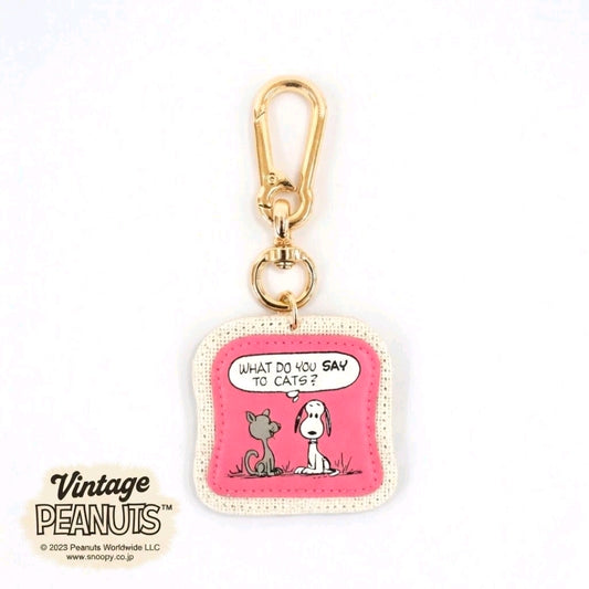Pink Snoopy keychain with cat-and-dog graphic and gold lobster clasp