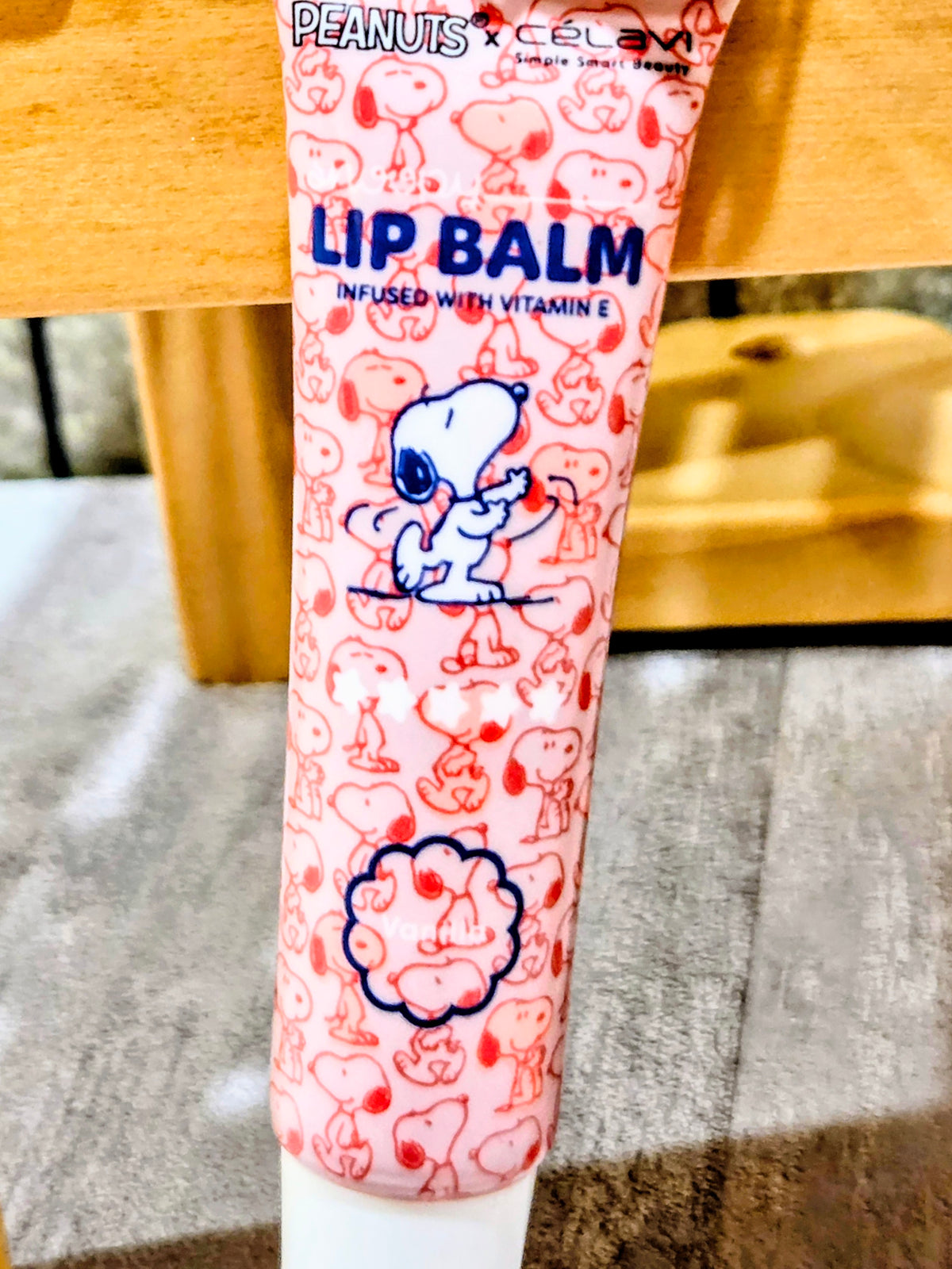 Lip balm tube with Snoopy print and white cap