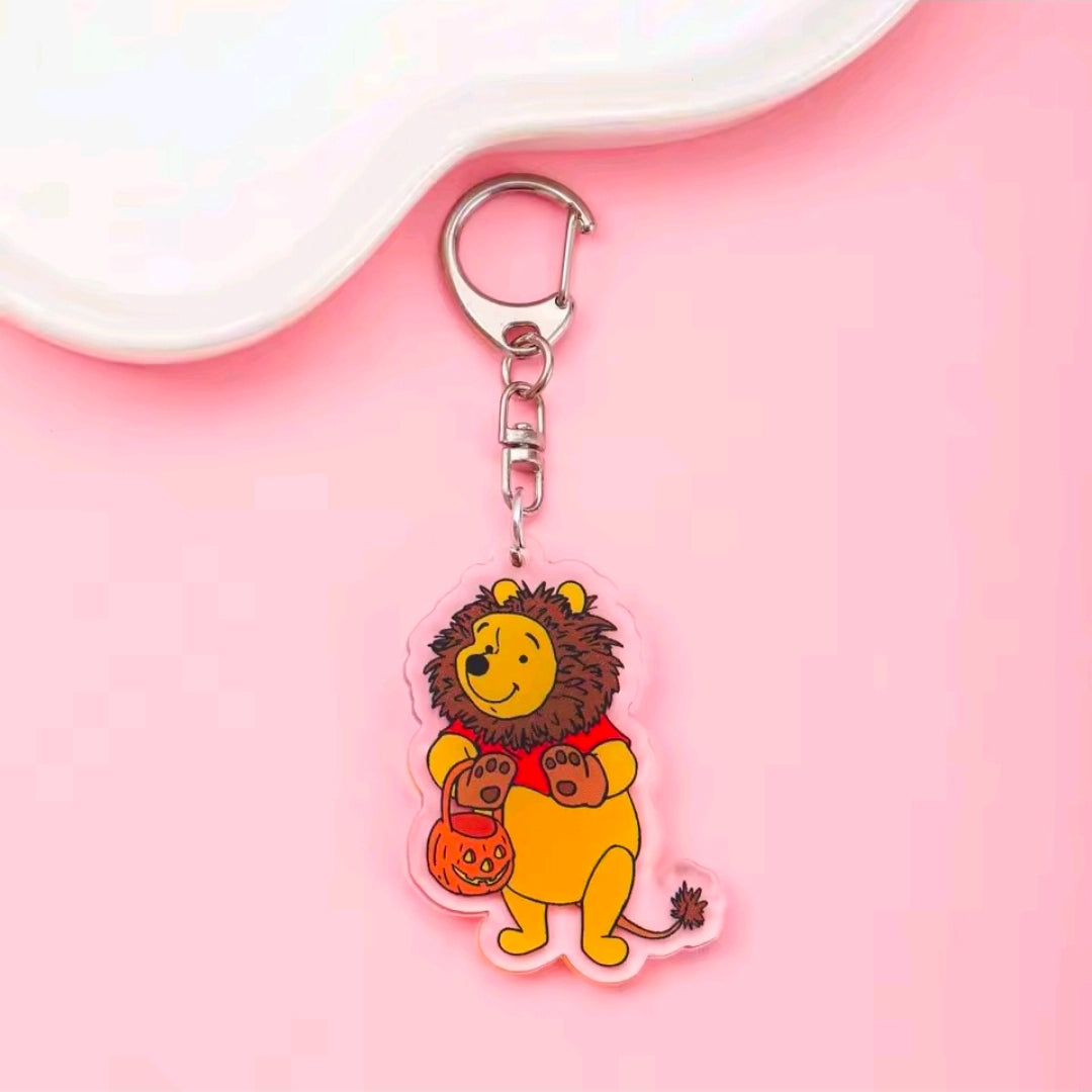 Acrylic Halloween keychain with carabiner; spiky brown animal holding a small orange pumpkin bucket charm.