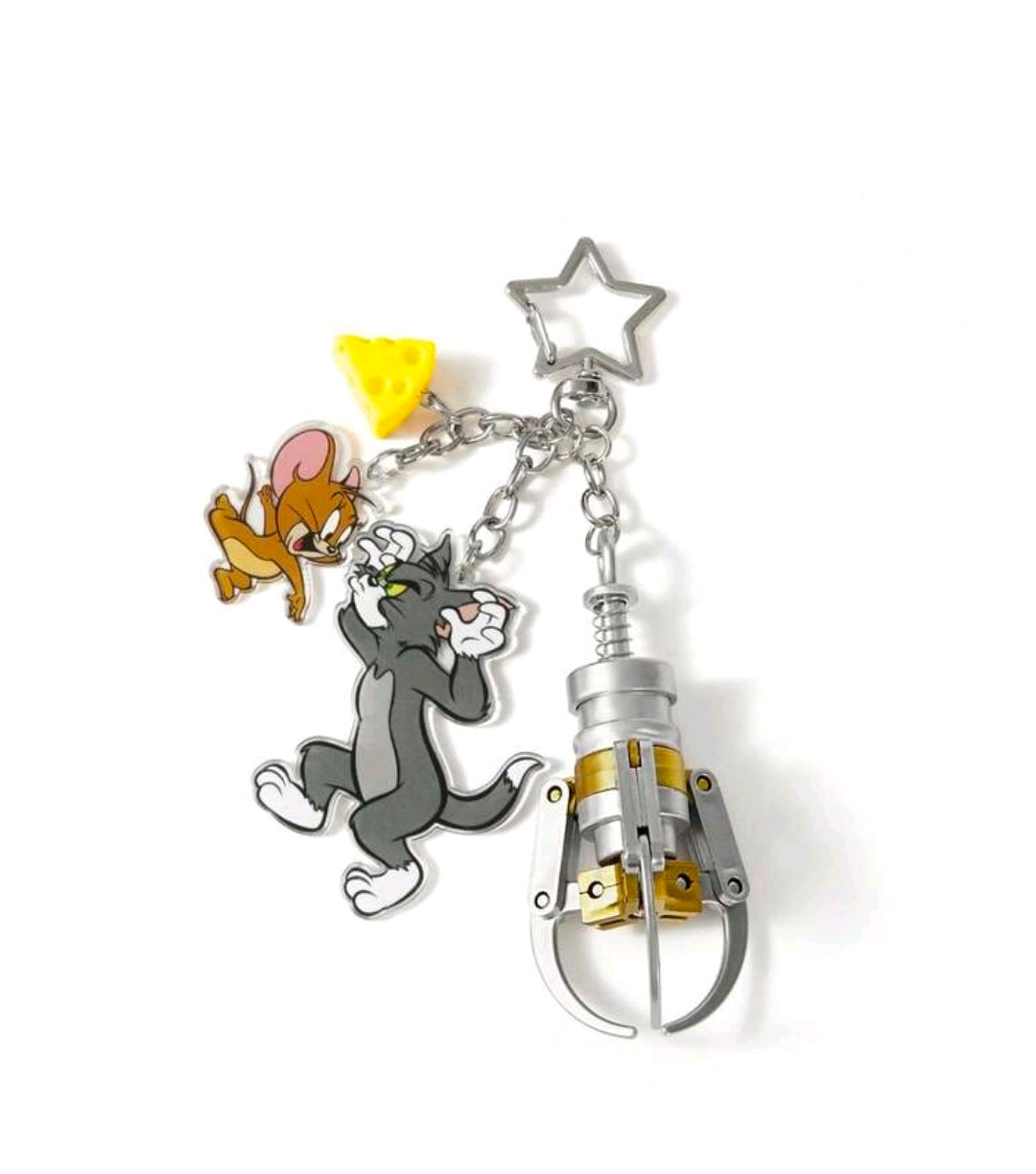 Tom & Jerry grabber claw keychain with silver claw piece, star charm, and chains