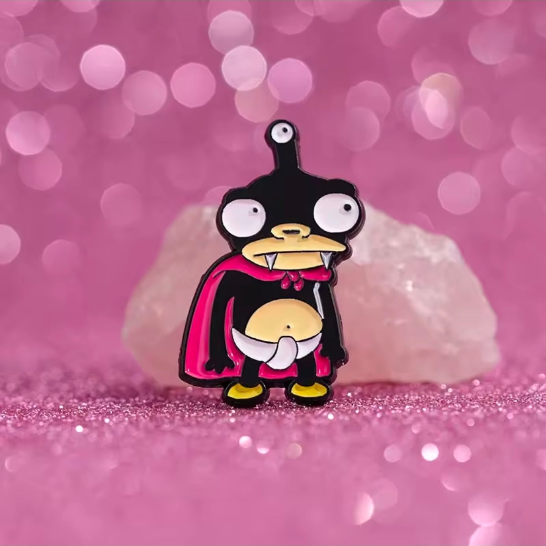 Nibbler enamel character pin with black hood, magenta cape, and gold belly