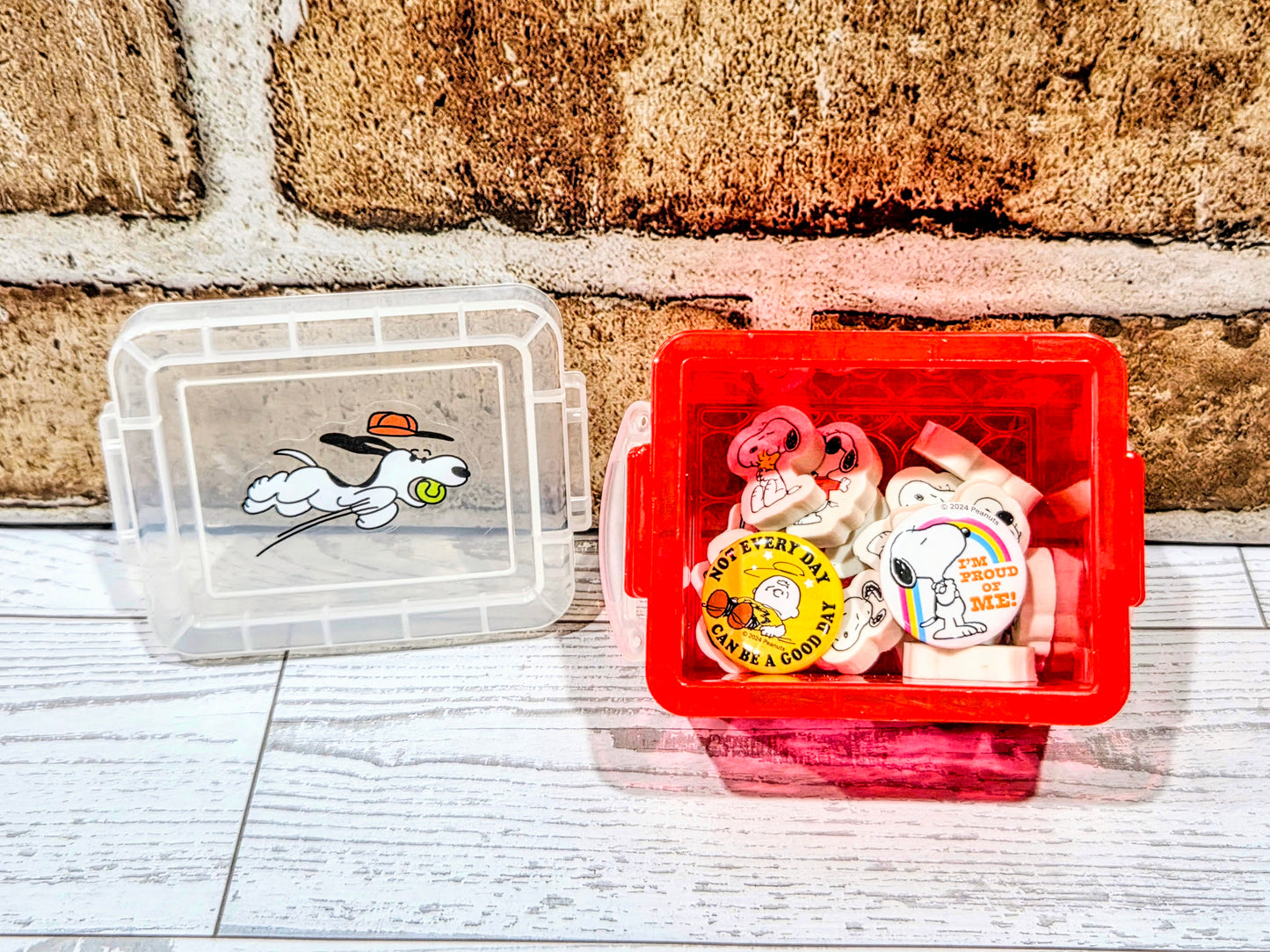 Mini organizer boxes, clear and red, with Snoopy erasers and pin badges inside