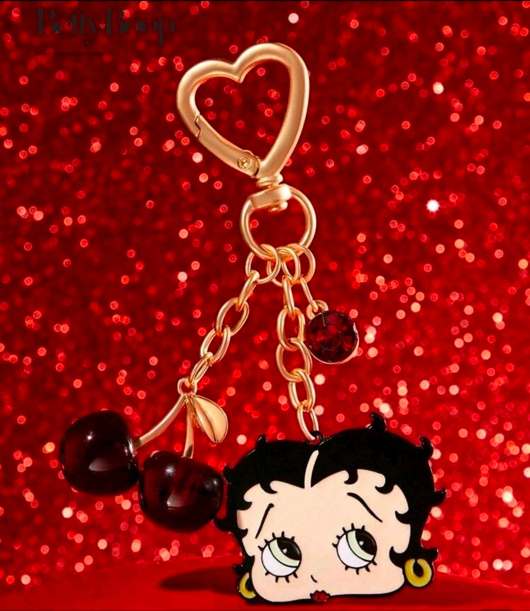 Gold-tone Betty Boop bag charm with red heart keyring and cherry bead accents