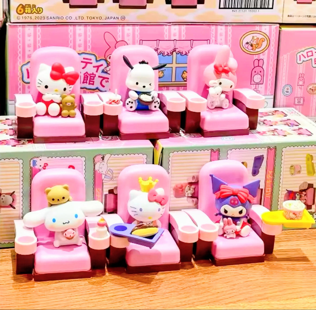 Mini blind box movie theater figures arranged in multiple pink seats