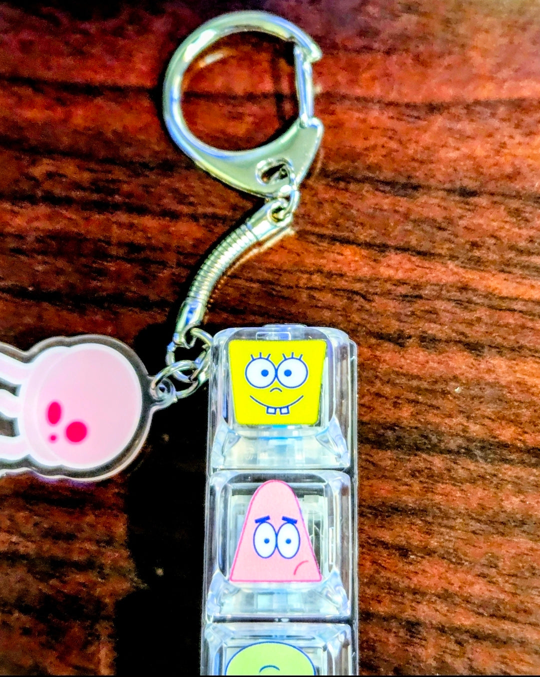 Clear acrylic keyboard fidget keychain with hand charm and keyring, four character panels