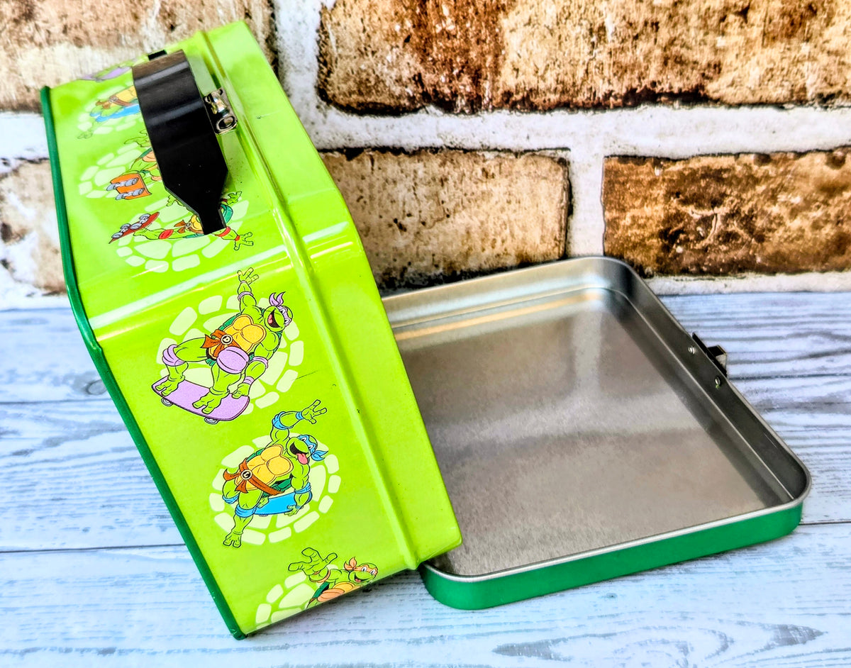 Teenage Mutant Ninja Turtles storage tin with open lid and metal tray