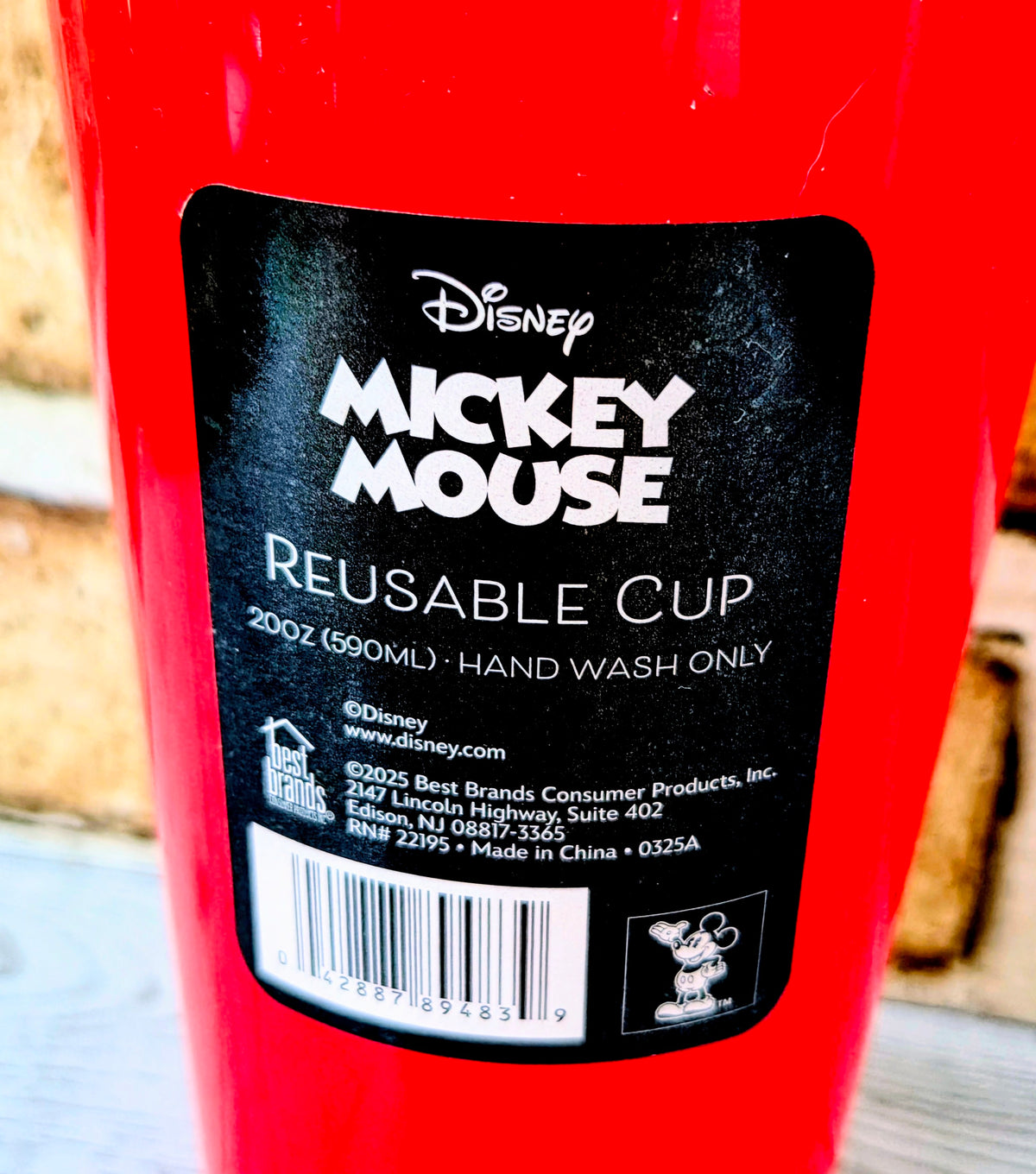 Red reusable cup with Disney Mickey Mouse label and hand wash oil text