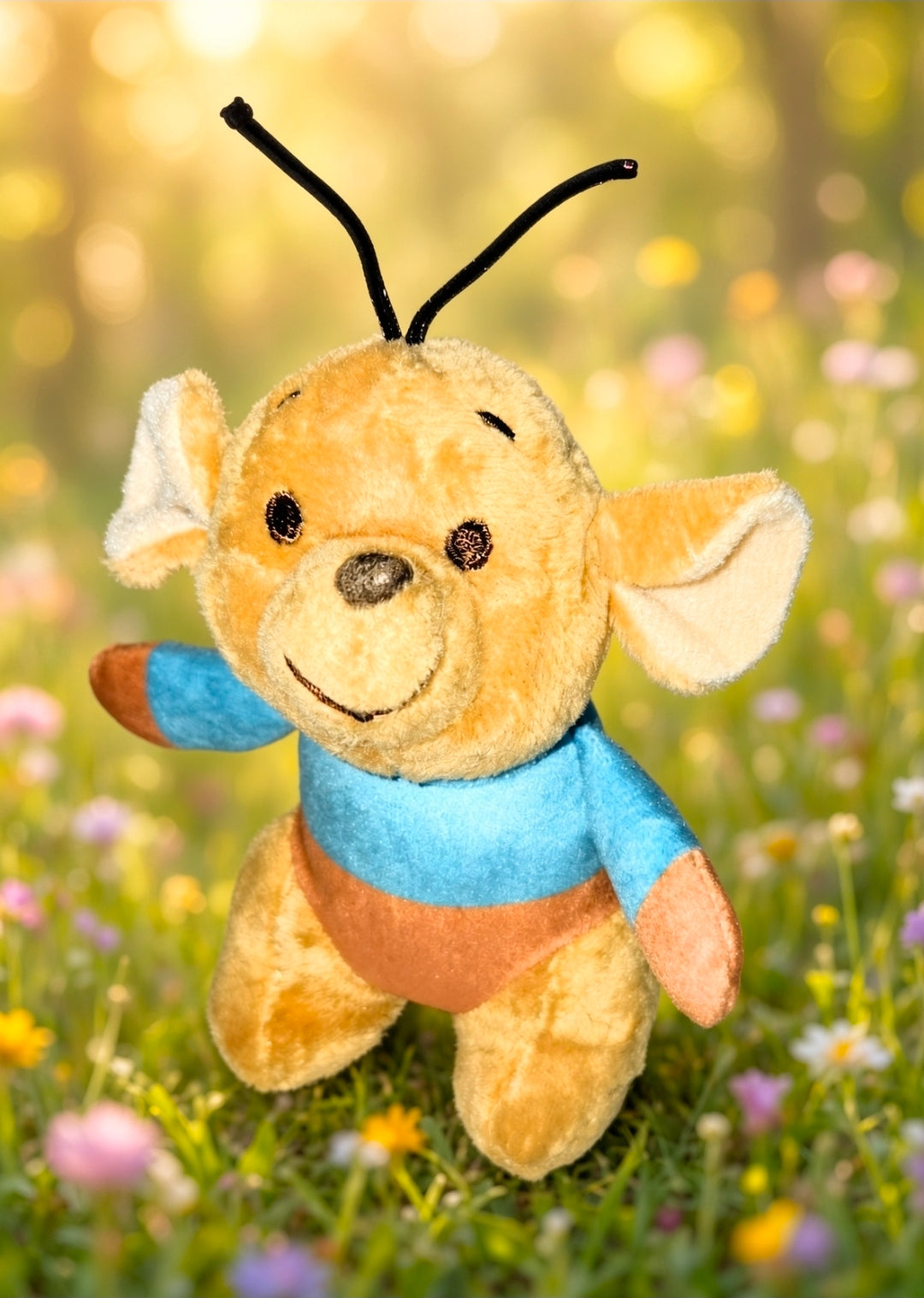 Roo mini plush keychain front view, smiling orange plush in blue shirt with black loop