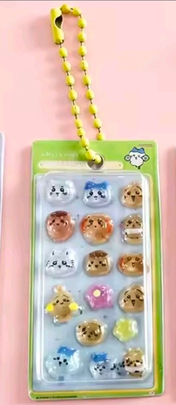 Green blister keychain with neon-yellow bead strap and mini Chiikawa sticker charms
