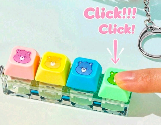 Four-color keychain clicker blocks in a clear case, with a finger pressing the top