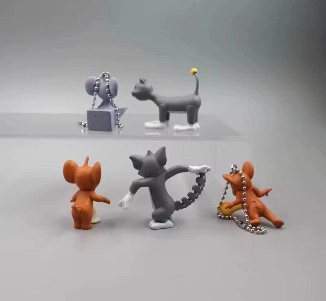 Five Tom and Jerry keychains showing three cat and two mouse figures with chains