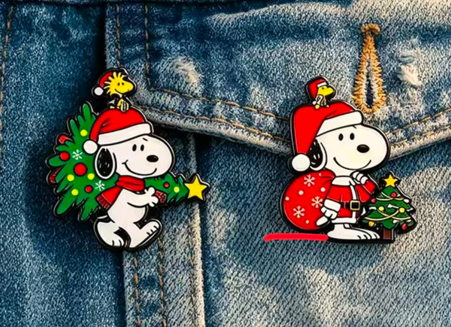 Snoopy Christmas enamel pins on denim: Santa-tree pin and sleigh Santa pin