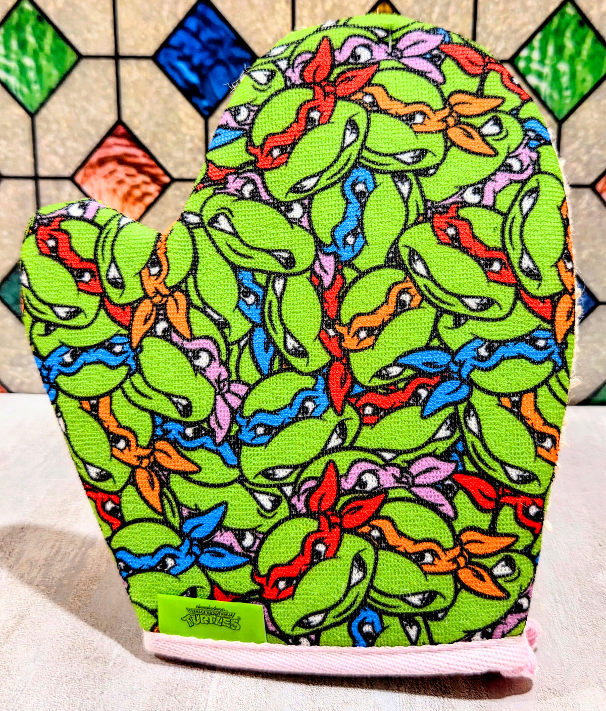 Green Teenage Mutant Ninja Turtles bath mitt with colorful character print