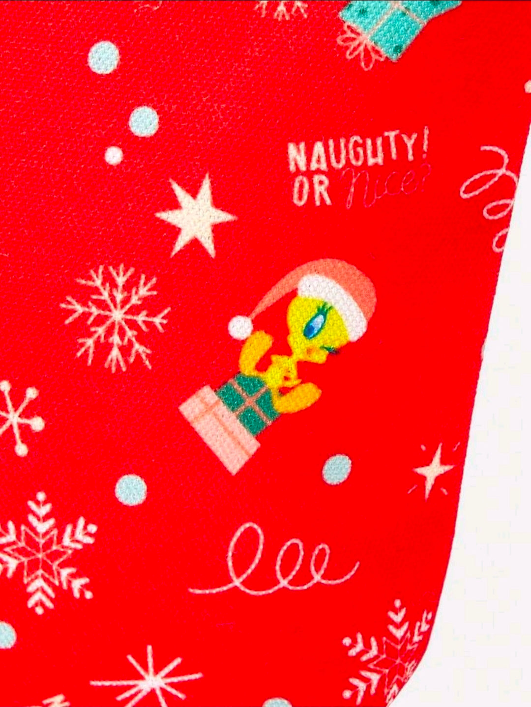 Red Christmas makeup bag with Tweety graphic, “NAUGHTY OR NICE” text, and snowflake pattern