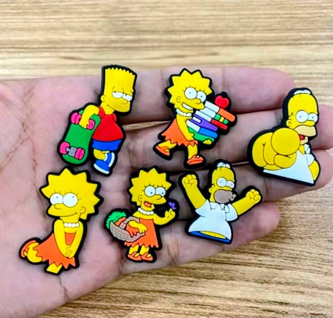 Simpsons shoe bag charms pins on palm, colorful cartoon characters