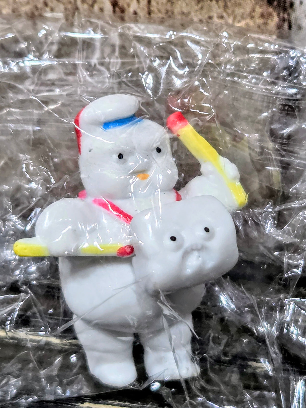 White Mini-Puft ghost figures in clear plastic bag holding yellow matchstick sticks