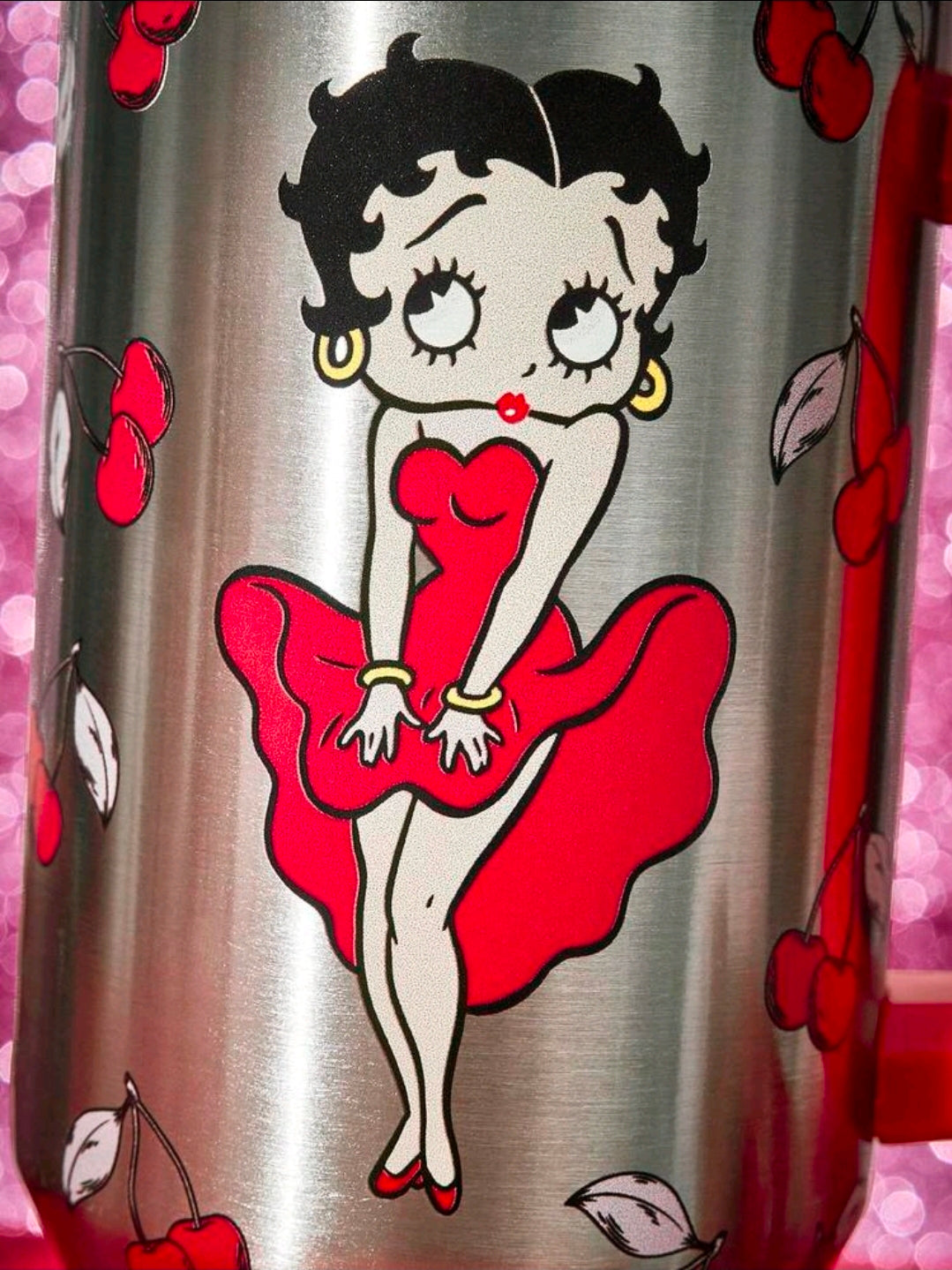 Stainless steel tumbler close-up of Betty Boop in red dress with heart/cherry print.