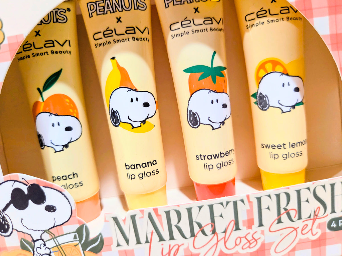 Four labeled lip gloss tubes in a box, showing peanuts characters and Market Fresh title