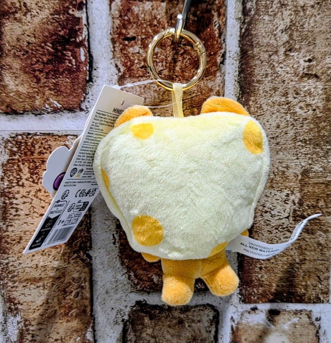 Yellow toast plush keychain showing back with small feet and hanging paper tag