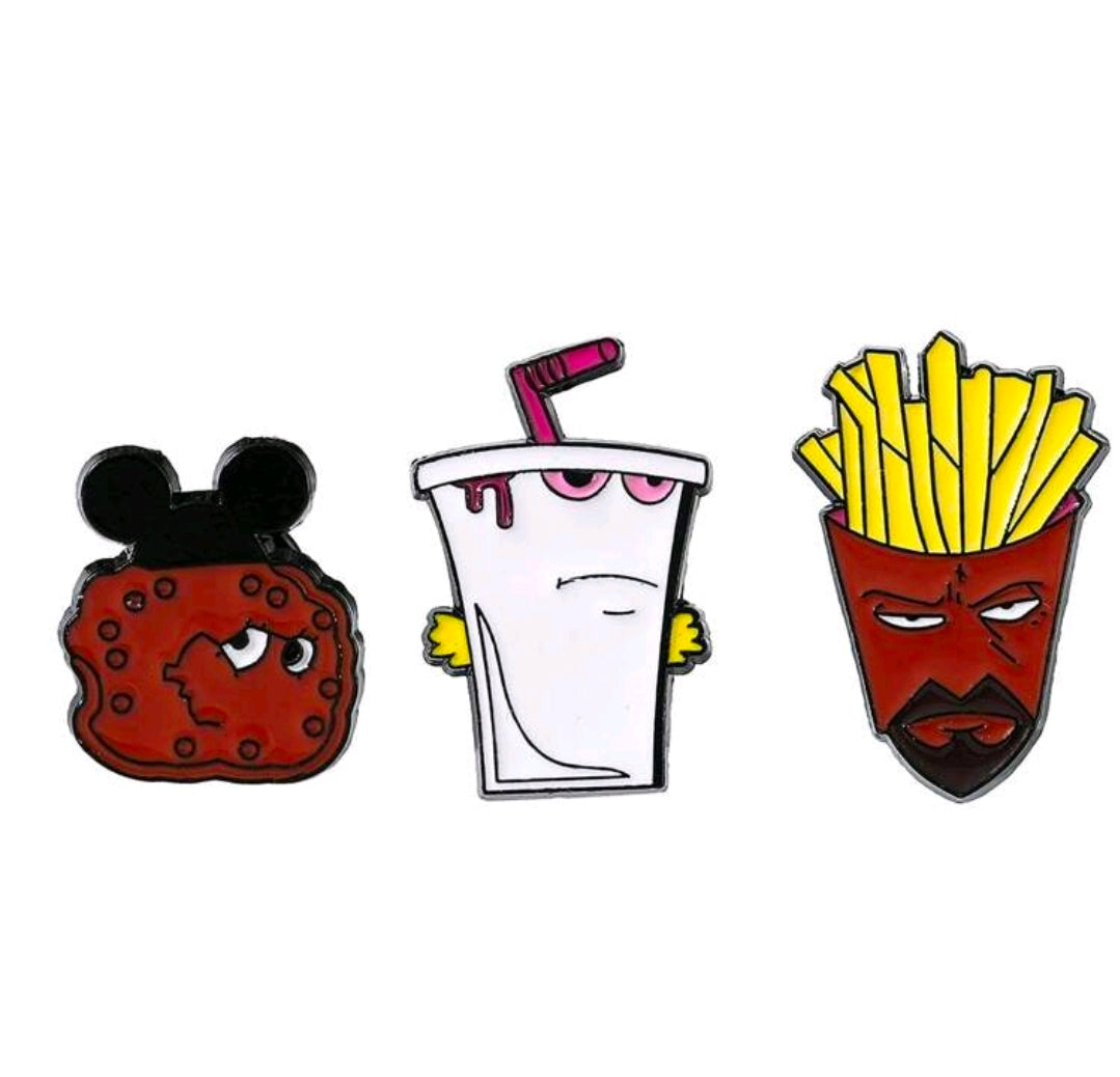 Three-piece enamel pin set showing shake cup, fries face, and red cookie character