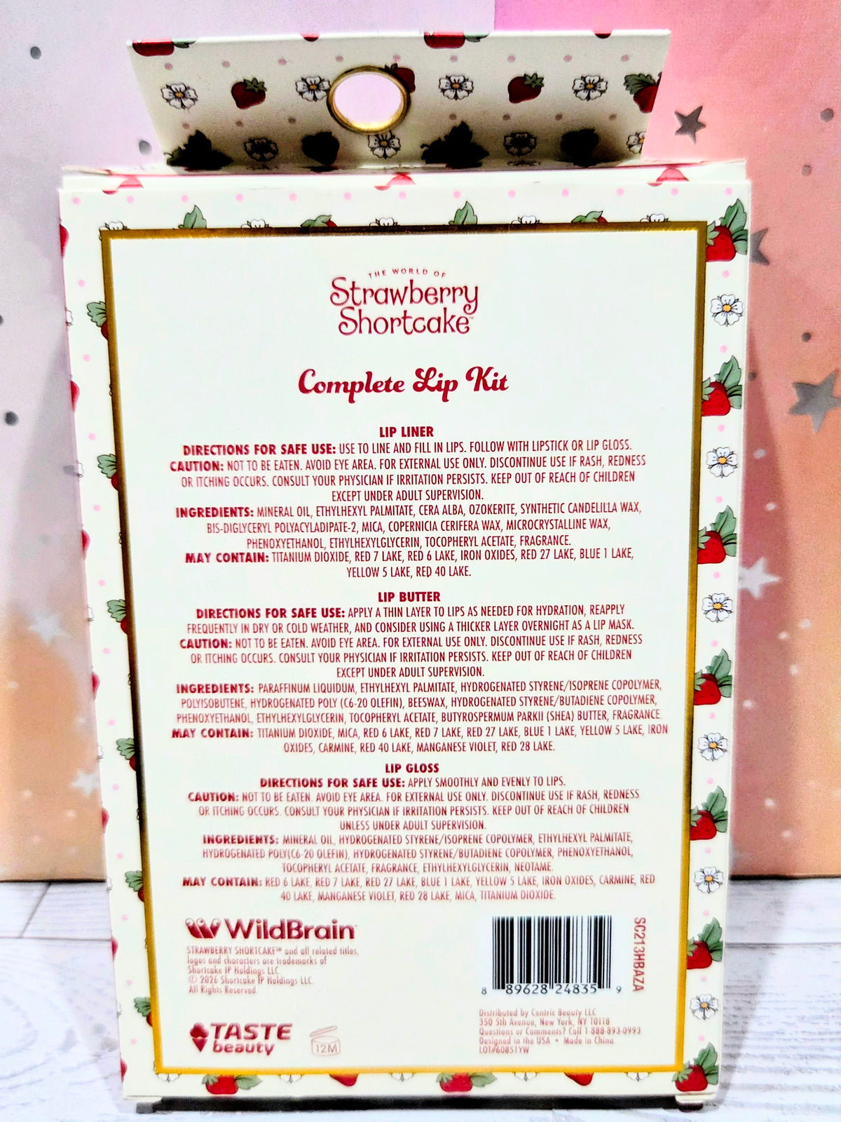 Strawberry-themed lip kit box with barcode and directions panel