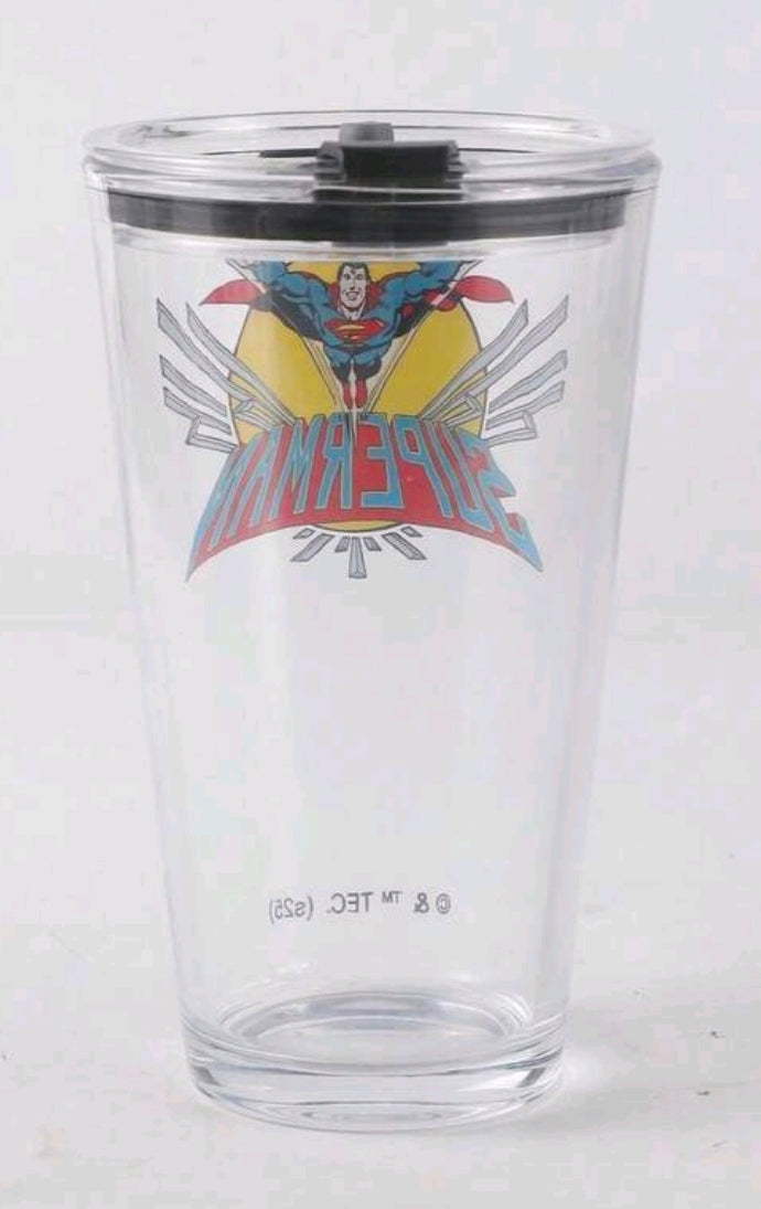 Clear glass tumbler with black lid and Superman star emblem.