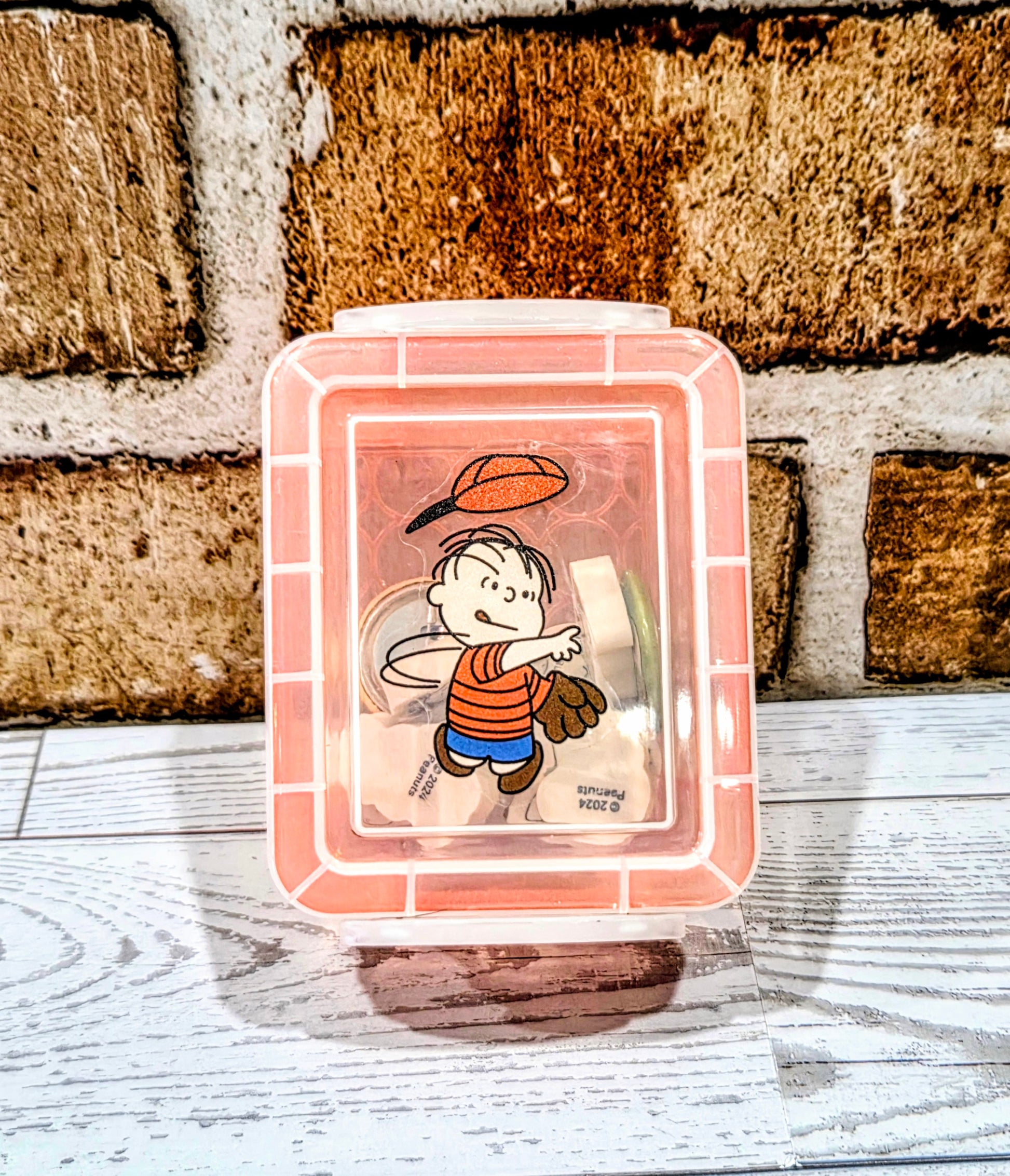 Orange desktop organizer box with Snoopy character on front window