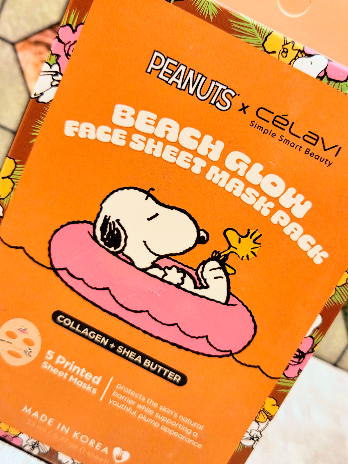 Beach glow face sheet mask box with Peanuts graphics and a reclining Snoopy illustration