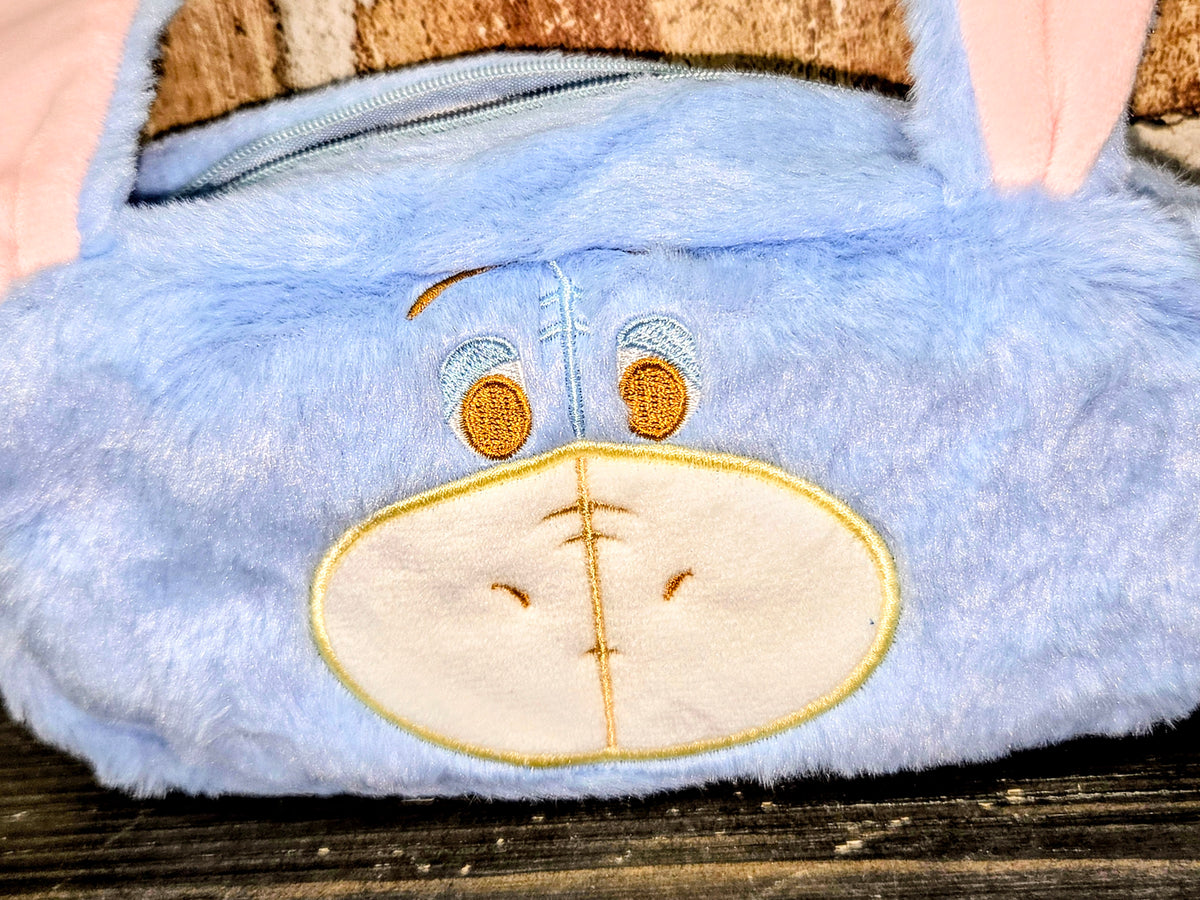 Eeyore plush zipper pouch close-up with stitched muzzle and golden nose patch