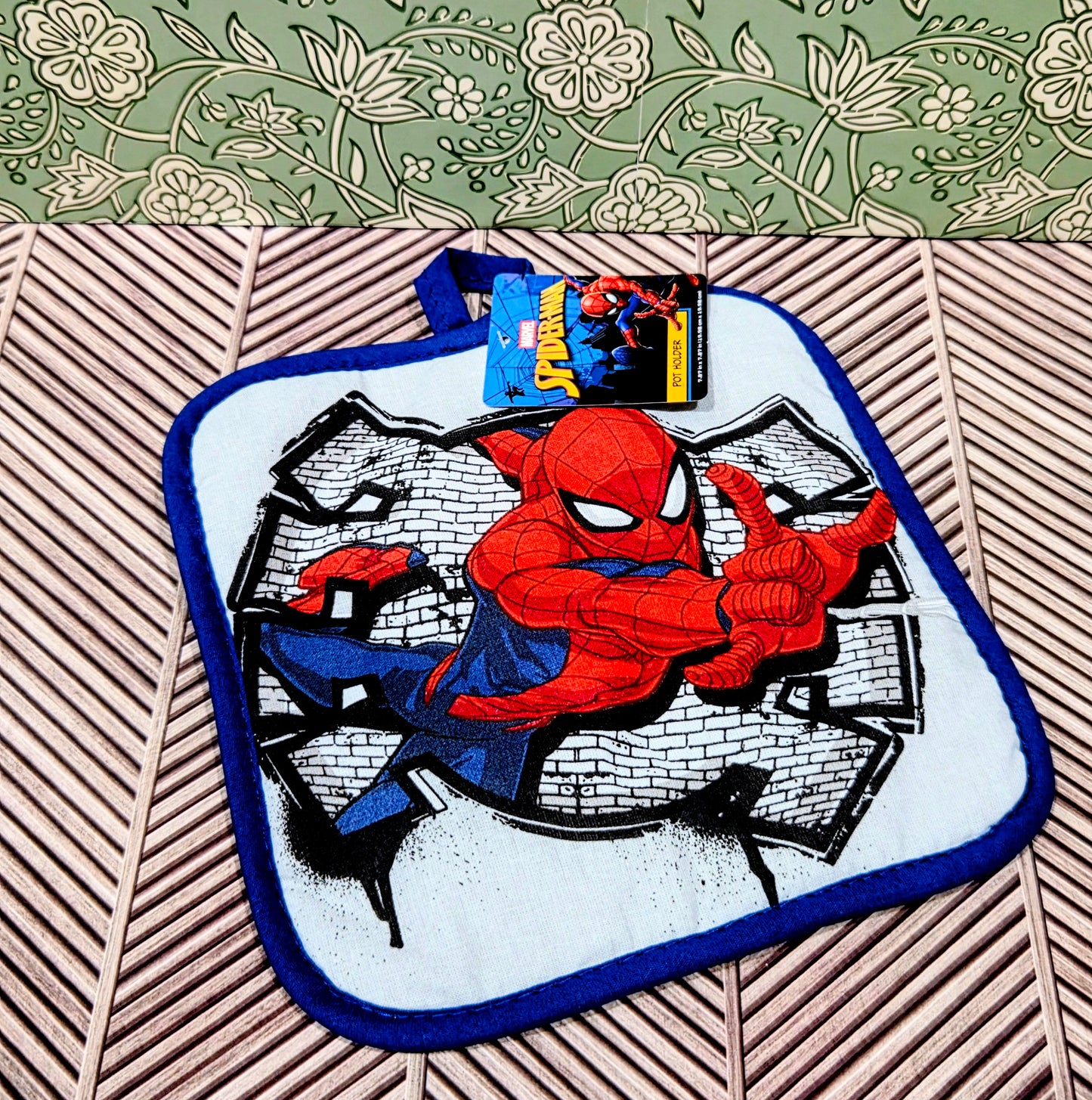 Spider-Man pot holder with red-and-blue character graphic on white square