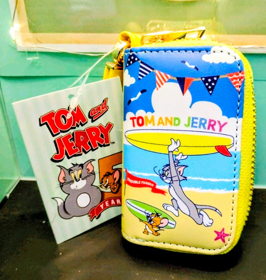 Blue smart key case with yellow zipper, Tom and Jerry surfboard artwork and tag