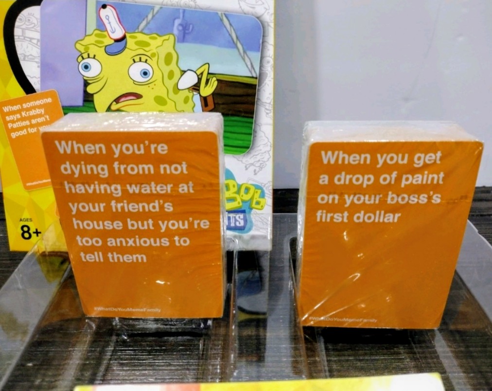 Card game box with SpongeBob SquarePants art and orange prompt cards
