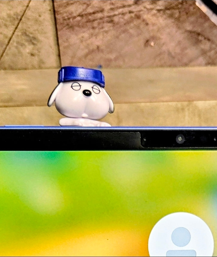 Blue-capped Olaf mini clip-on sleeping figure facing forward on laptop keyboard