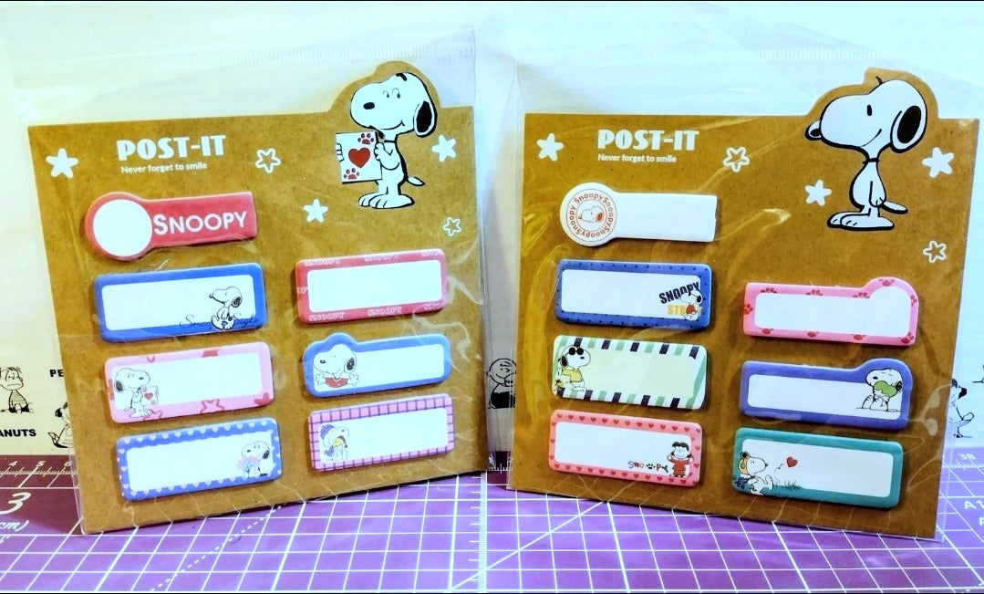 Two POST-IT Snoopy sticky tab sets, assorted pastel rectangular tabs in packs