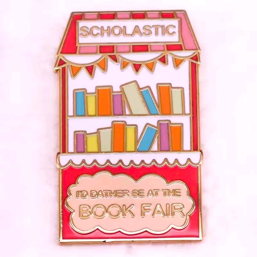 Colorful Scholastic Book Fair storefront enamel pin with red and gold border.