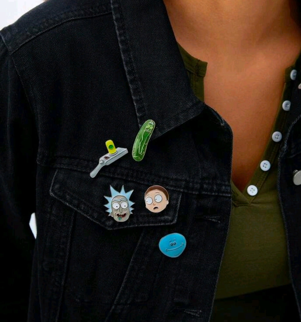Enamel pins on denim jacket: pickle Rick, Rick head, Meeseeks face, blue portal